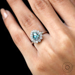 Detailed halo diamonds around pear moissanite ring