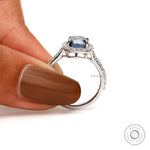 White gold engagement cathedral ring with deep blue center stone