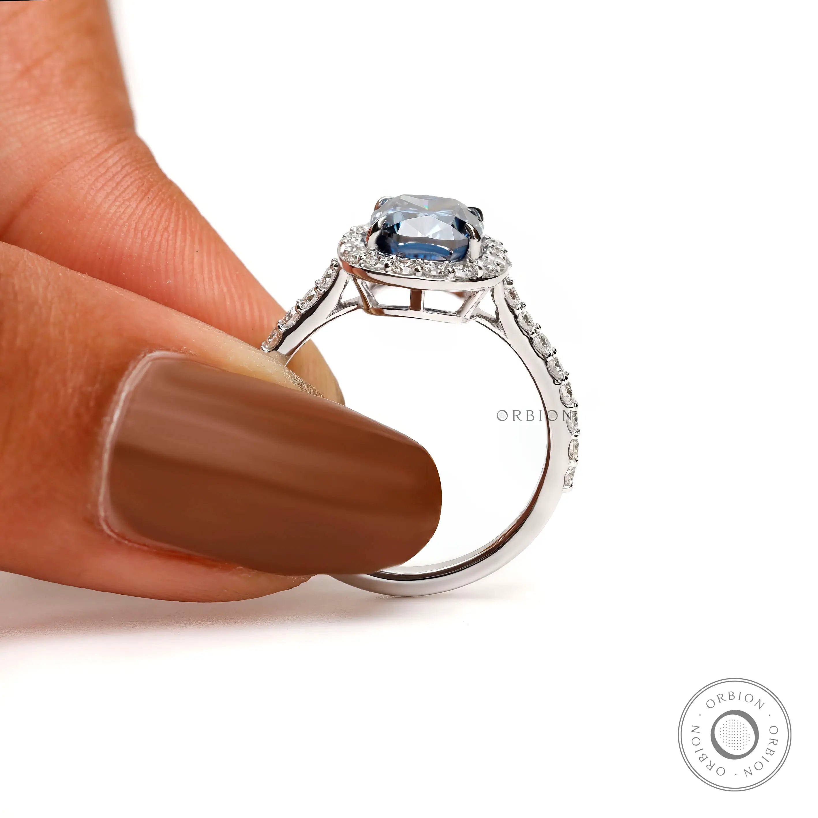 White gold engagement cathedral ring with deep blue center stone