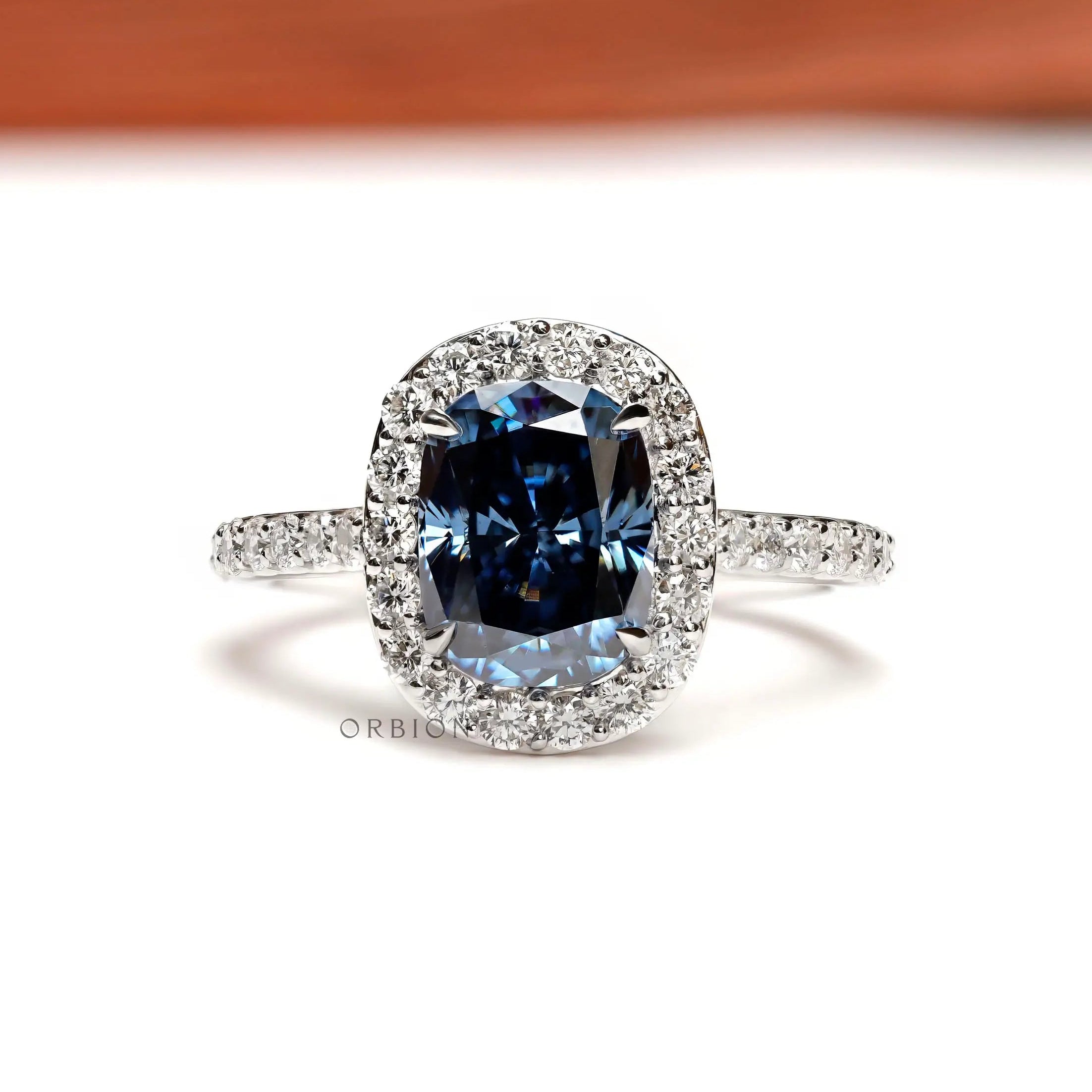 Elongated cushion deep blue moissanite halo ring front view