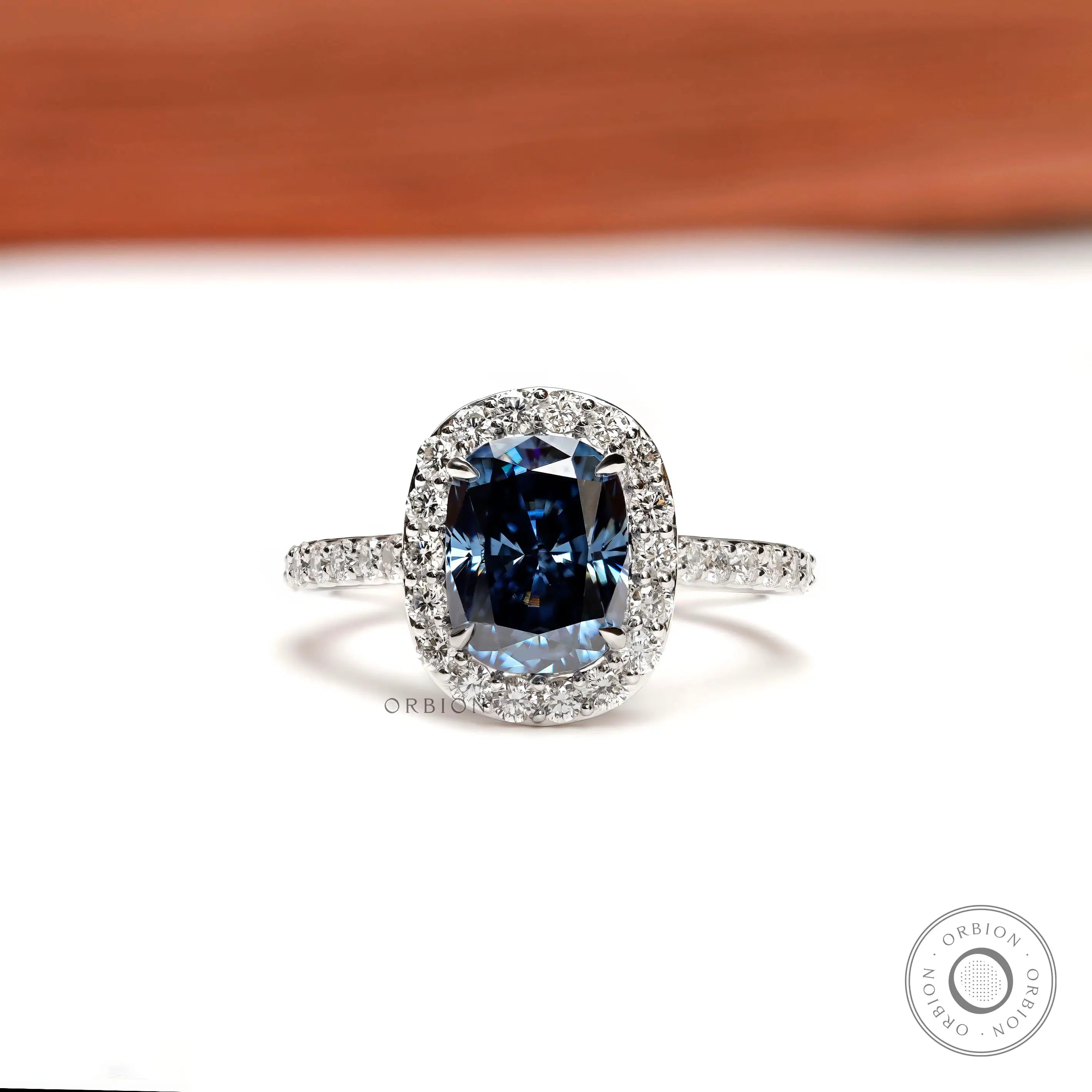 Elongated cushion deep blue moissanite halo ring front view