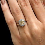 Close up of elongated cushion moissanite with round halo stones