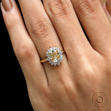 Close up of elongated cushion moissanite with round halo stones