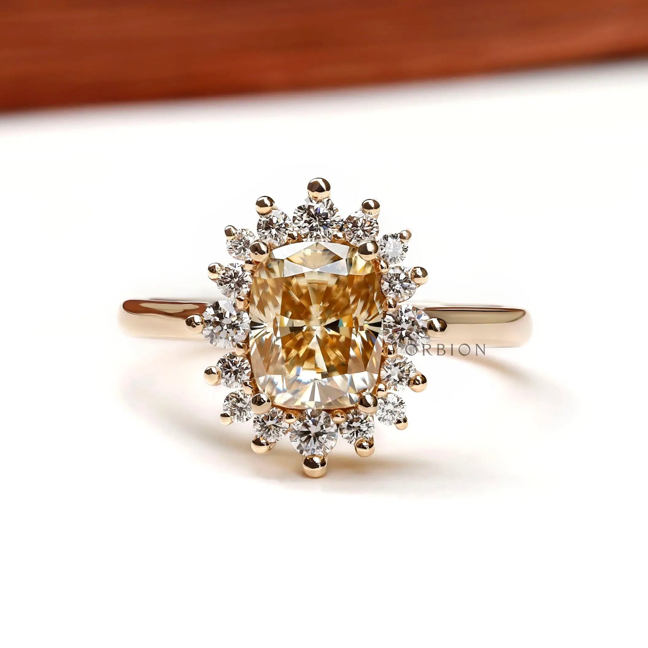 Elongated cushion yellowish champagne moissanite halo engagement ring front view