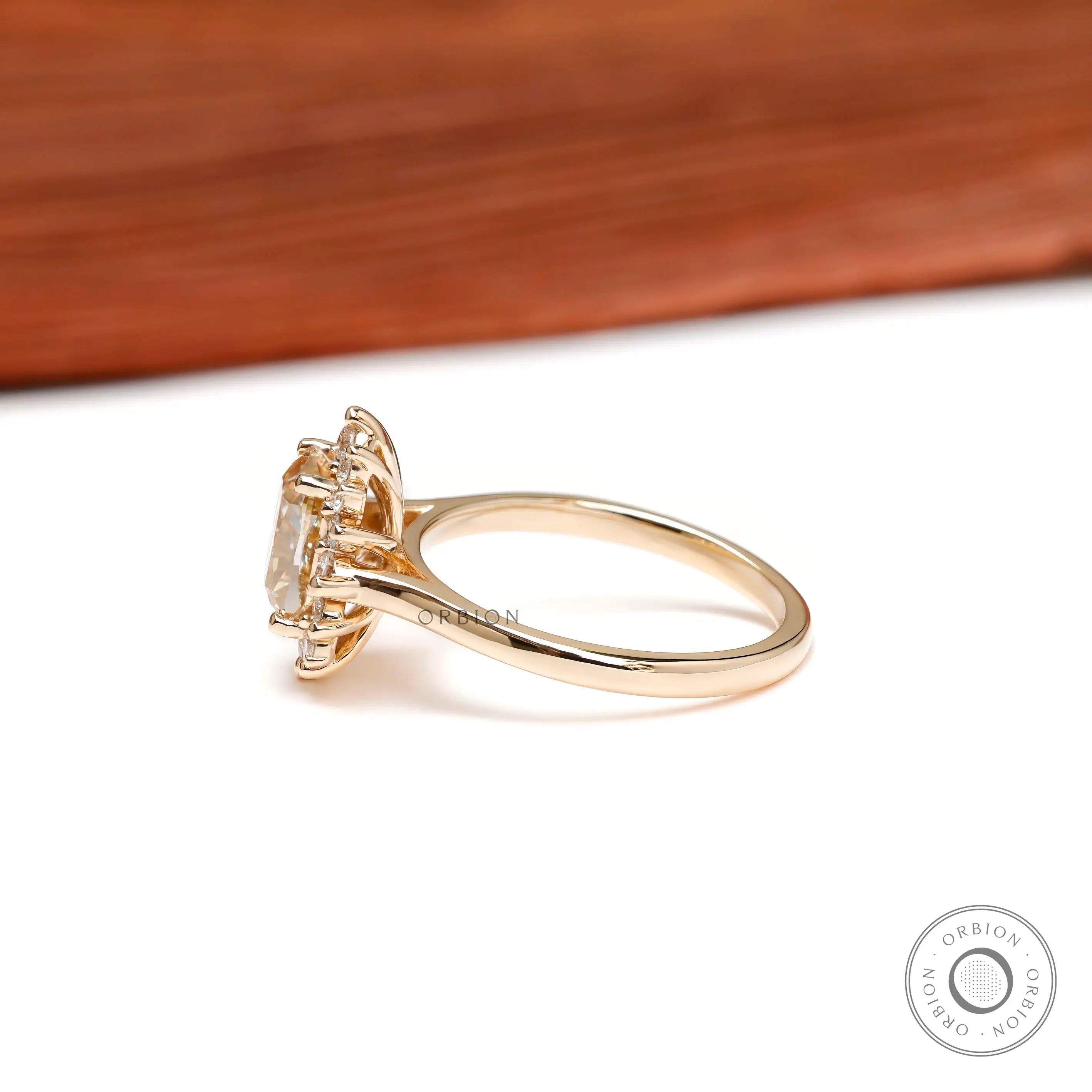 Slim band yellow gold halo engagement ring angled view