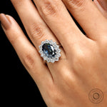 Deep blue oval moissanite ring with round halo stones