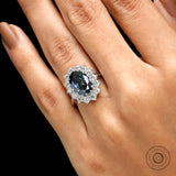 Deep blue oval moissanite ring with round halo stones