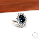 Side profile oval blue moissanite halo engagement ring white gold