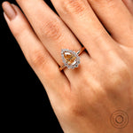 Close up of pear champagne moissanite with halo setting