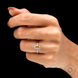 Halo engagement ring with pear shaped center stone on fingure