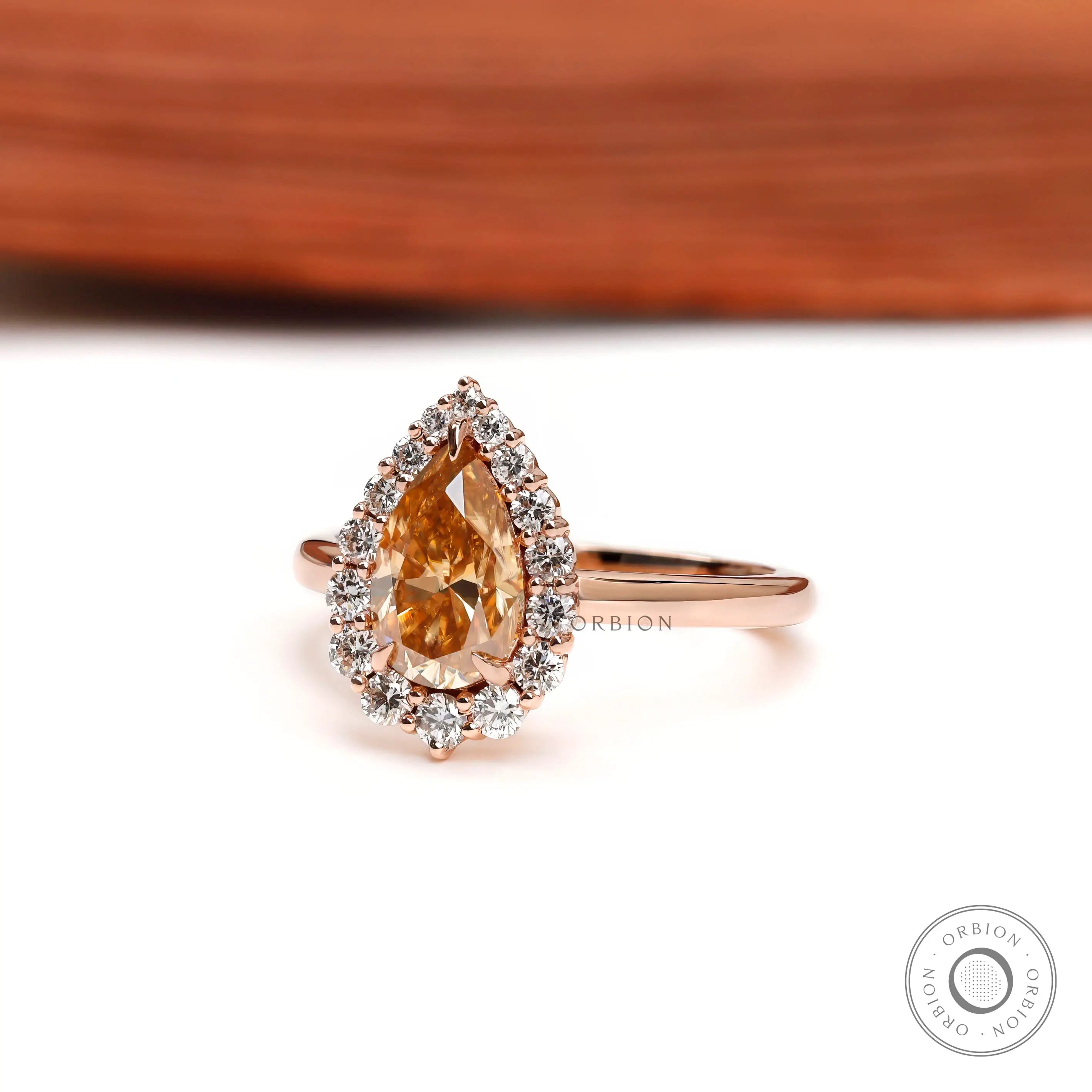 Side profile of pear champagne moissanite halo engagement ring