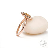 Rose gold champagne moissanite halo ring angled view