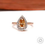 Pear champagne moissanite halo ring front view in 14k rose gold