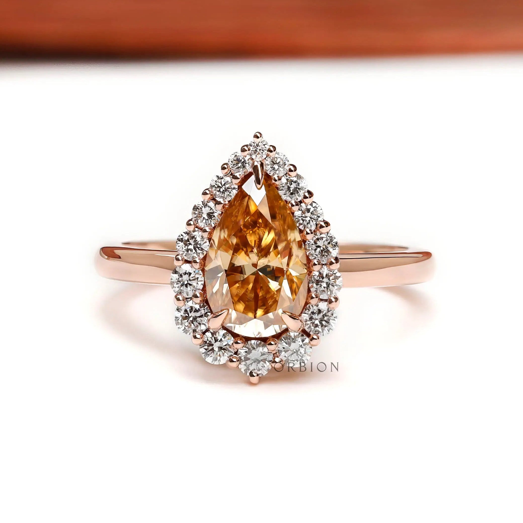 Pear champagne moissanite halo ring front view in 14k rose gold