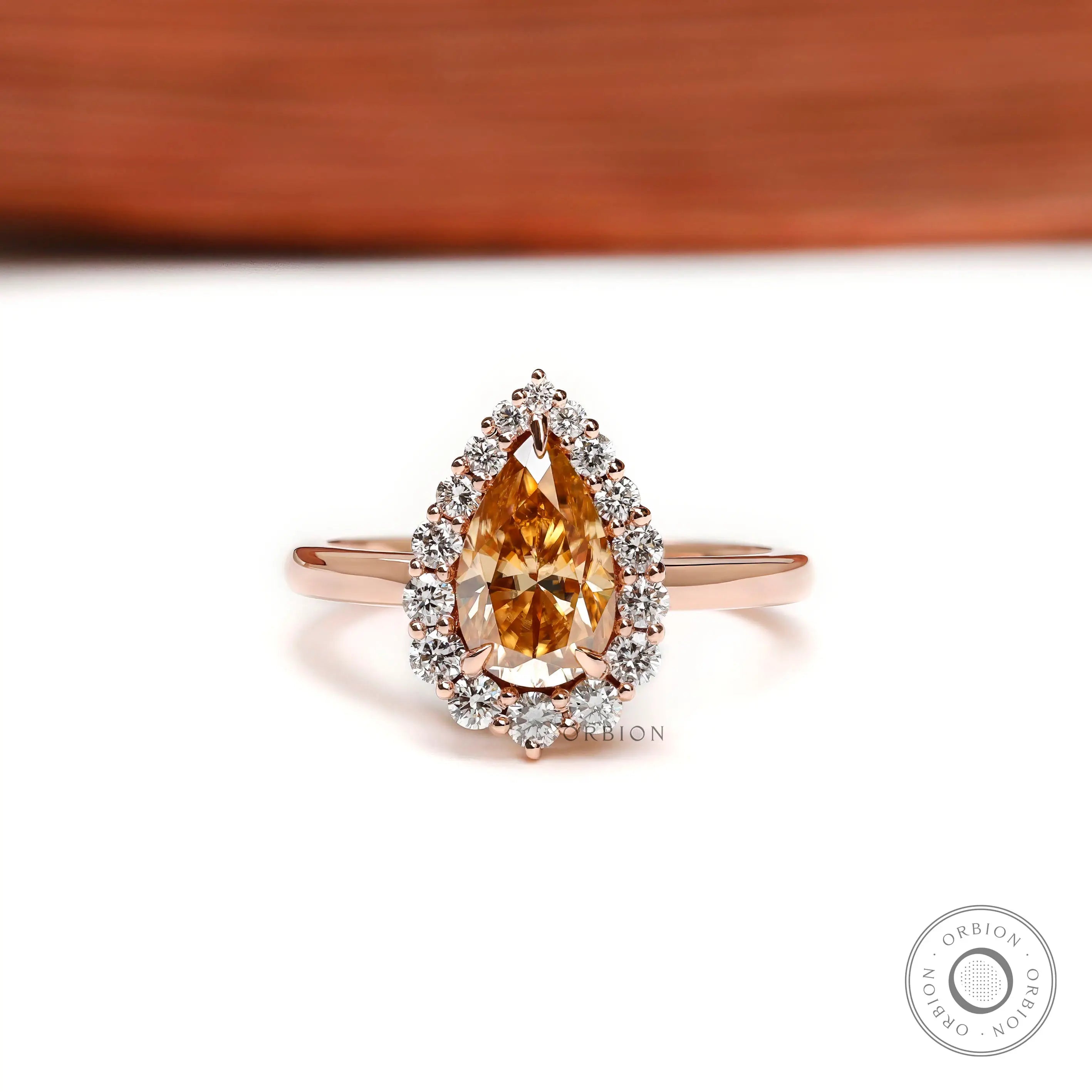 Pear champagne moissanite halo ring front view in 14k rose gold