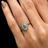 Teal moissanite halo engagement ring yellow gold close up