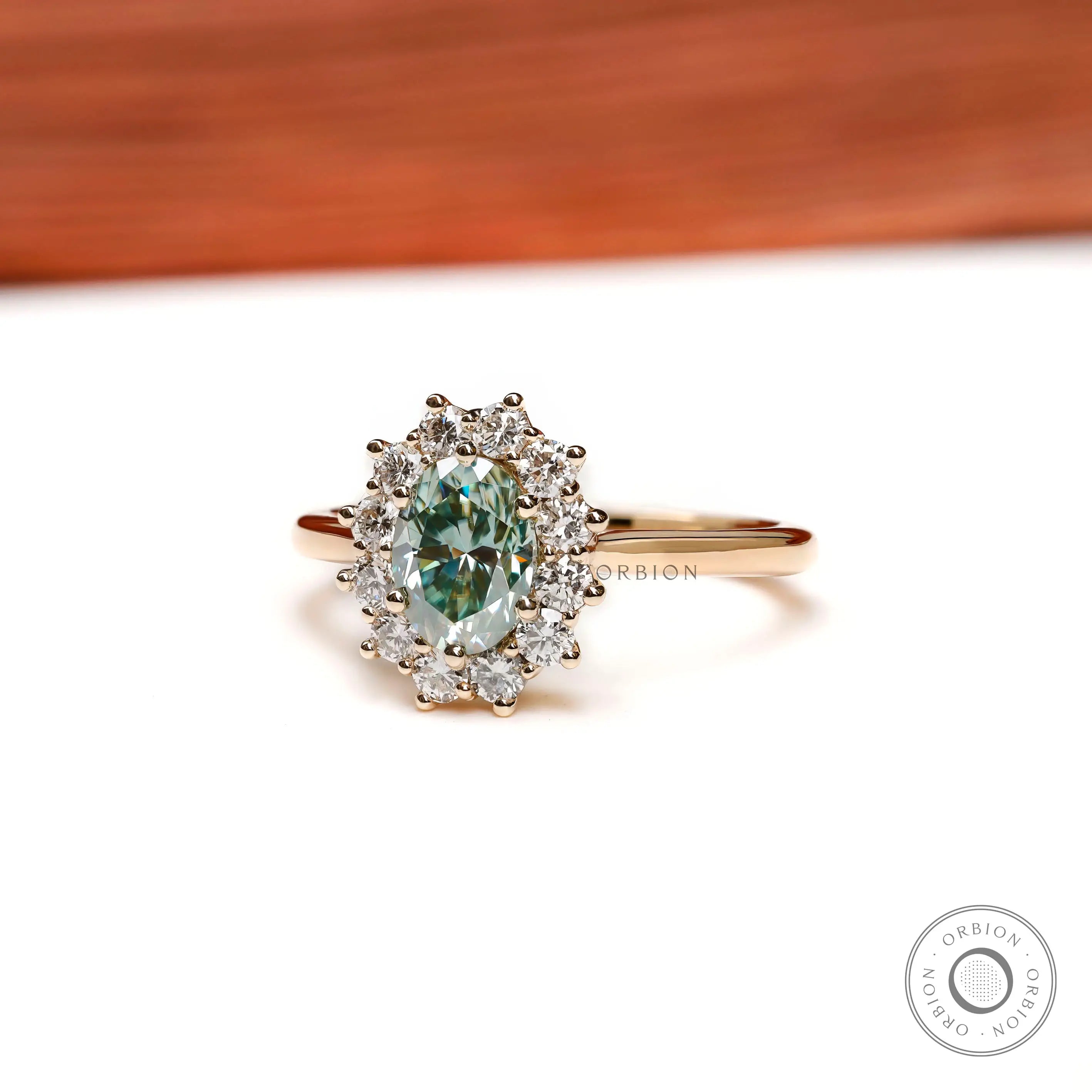 Oval blue green moissanite halo ring side profile yellow gold