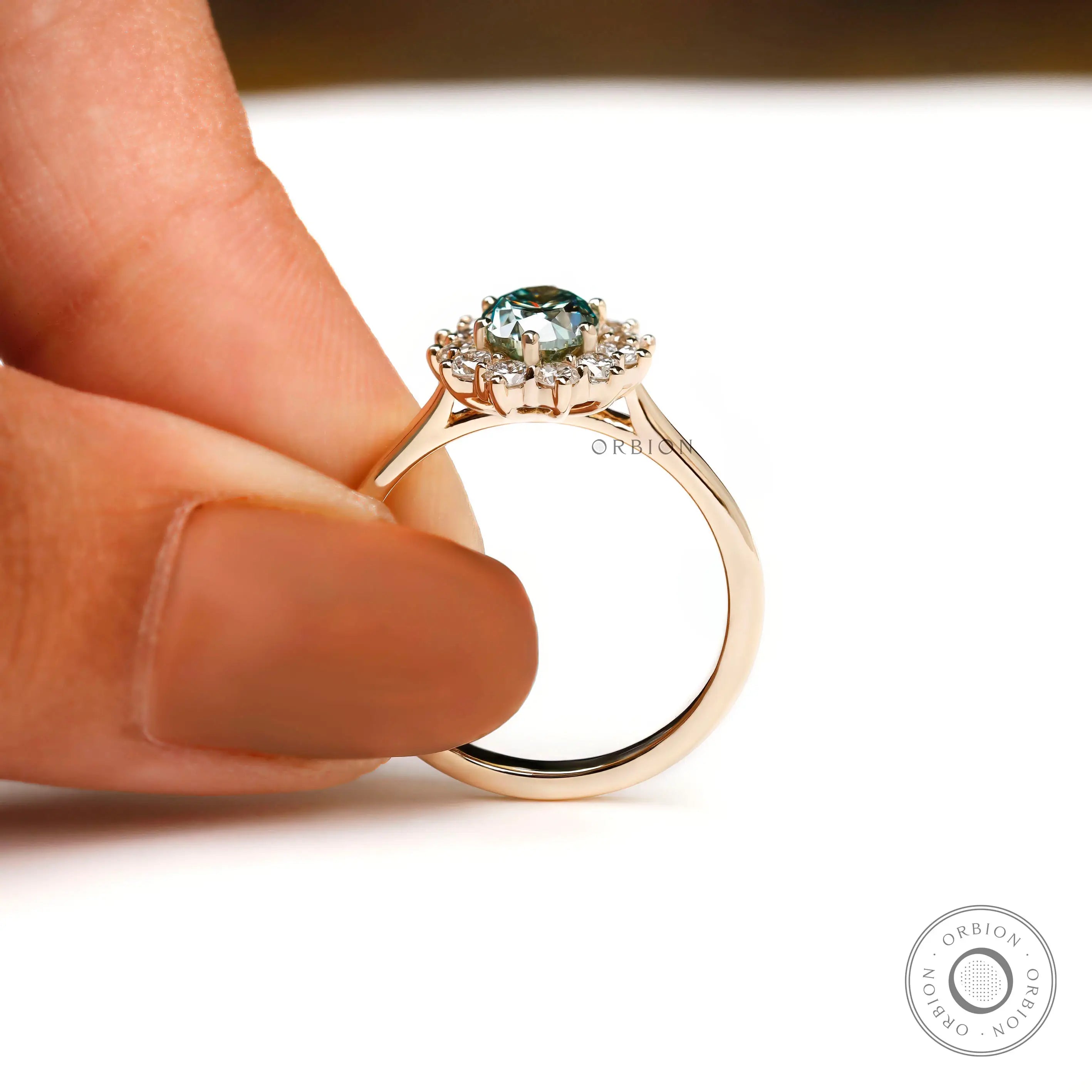 Oval blue green gemstone halo ring front view