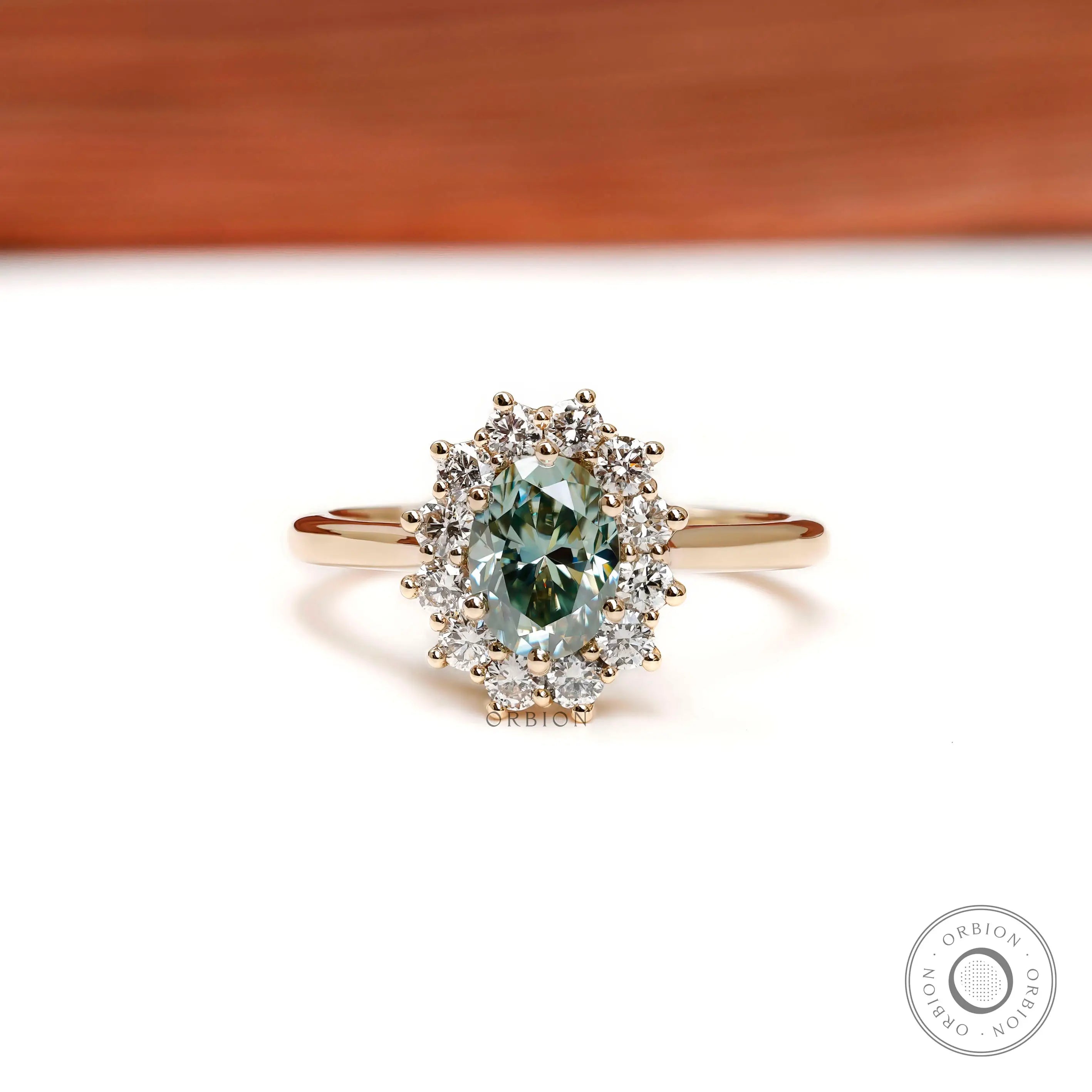 Oval blue green moissanite halo engagement ring in yellow gold