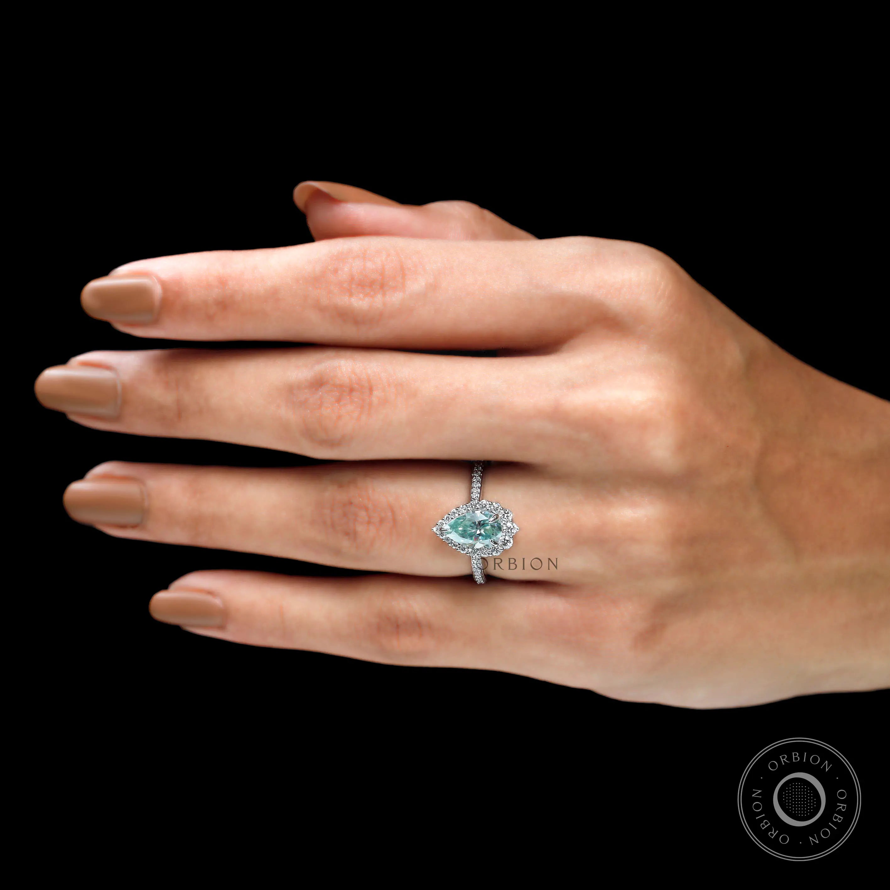 Pear cut light green moissanite halo ring on fingure