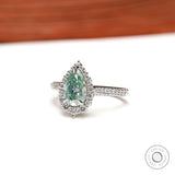 Side view of pear halo light green moissanite ring in white gold
