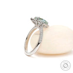 Bridal halo ring with pave shank and pear moissanite