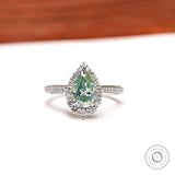 Light green pear moissanite halo engagement ring in 14K white gold