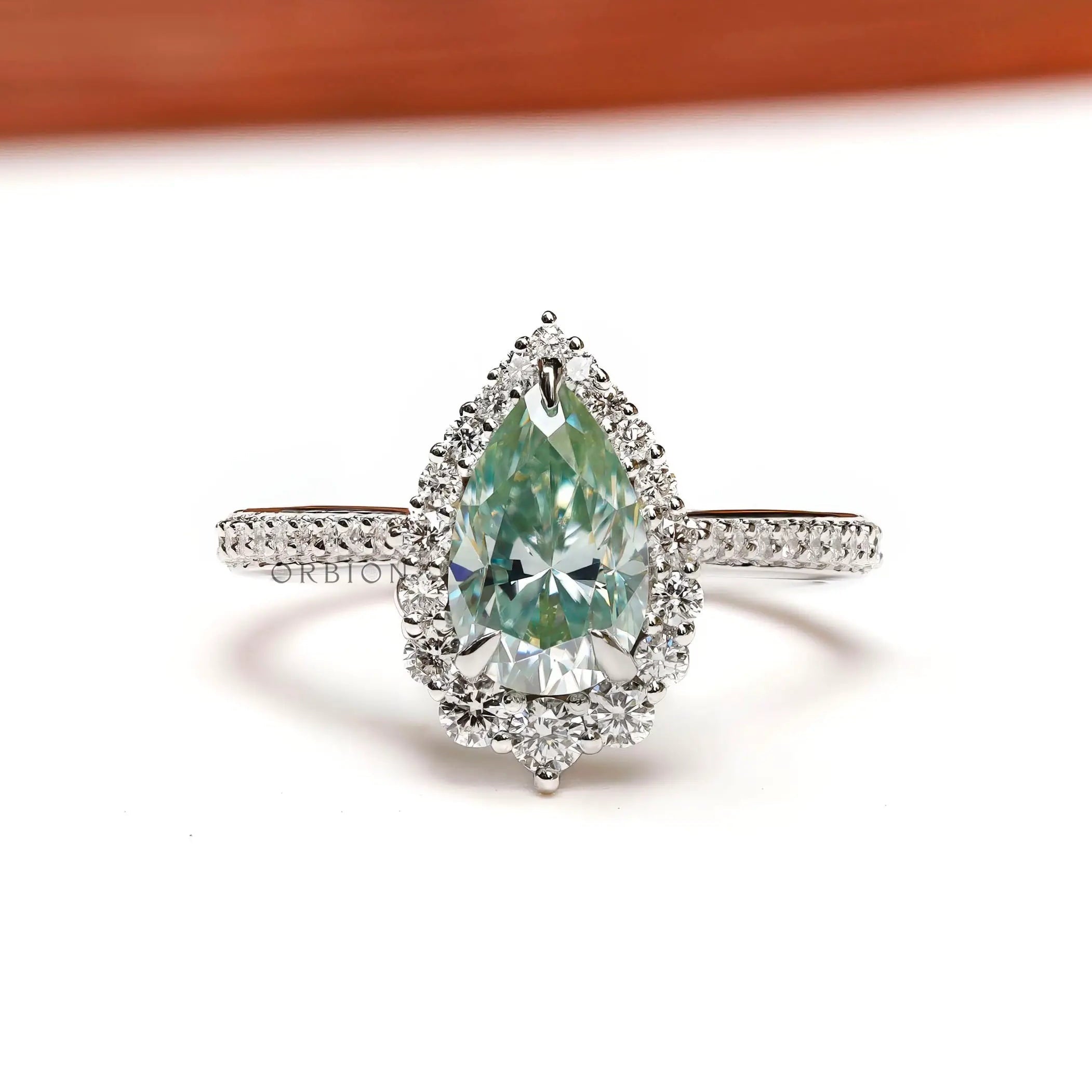 Light green pear moissanite halo engagement ring in 14K white gold