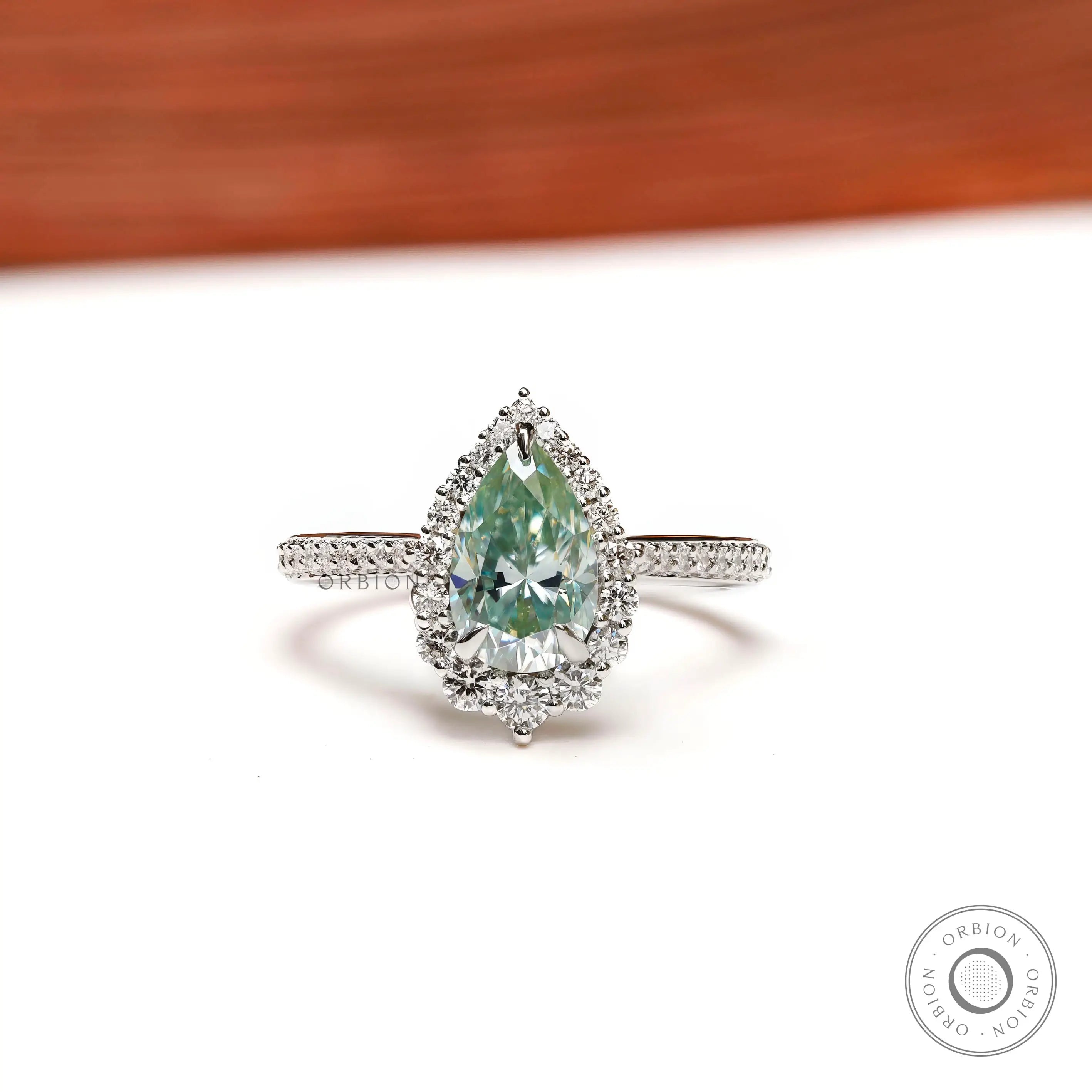 Light green pear moissanite halo engagement ring in 14K white gold