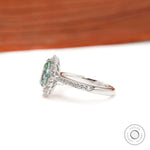 Pave band halo engagement ring with light green moissanite