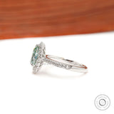 Pave band halo engagement ring with light green moissanite