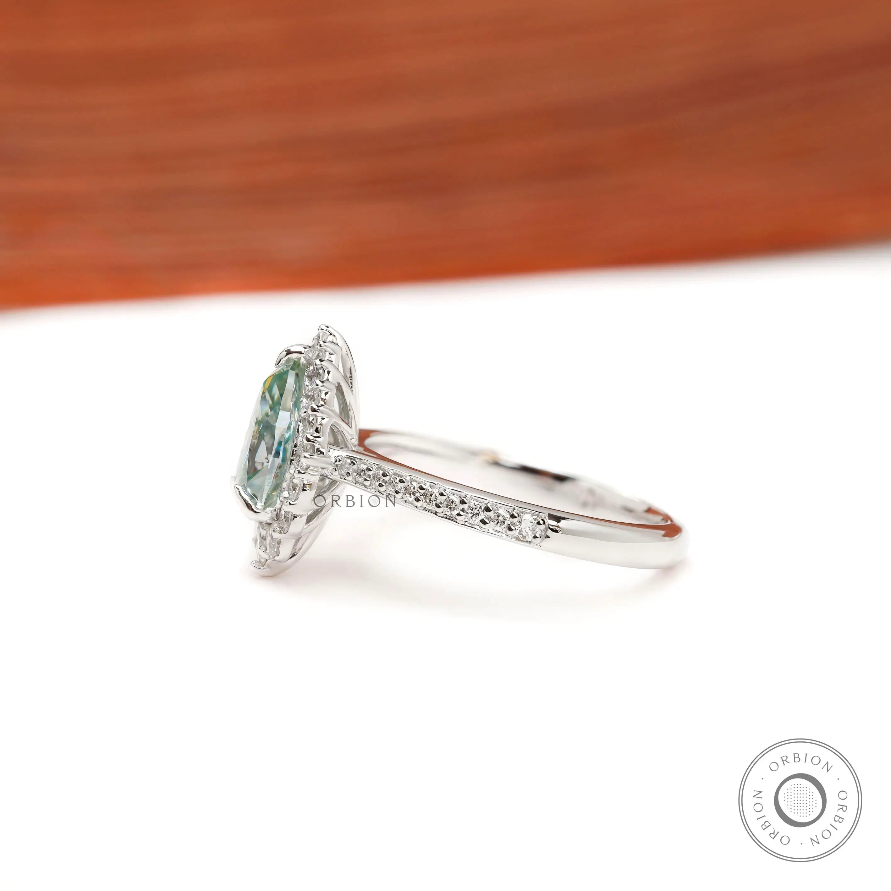 Pave band halo engagement ring with light green moissanite