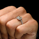 Yellow champagne moissanite ring with diamond halo on fingure
