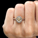Vintage style halo engagement ring with champagne moissanite close up