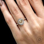Close up of champagne moissanite halo with round brilliant diamonds