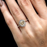Close up of champagne moissanite halo with round brilliant diamonds