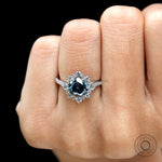 Round brilliant dark grey moissanite halo ring white gold close up