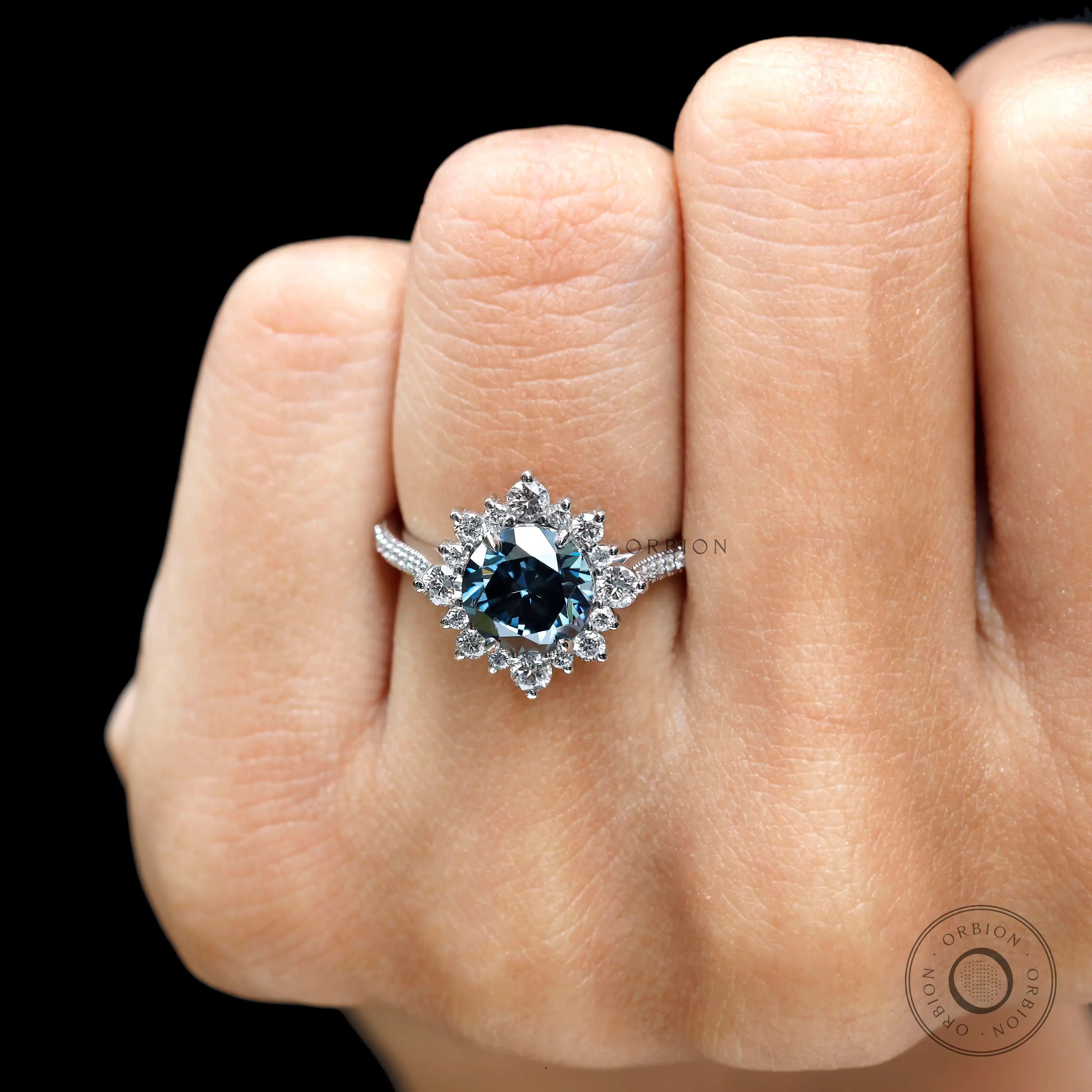 Round brilliant dark grey moissanite halo ring white gold close up