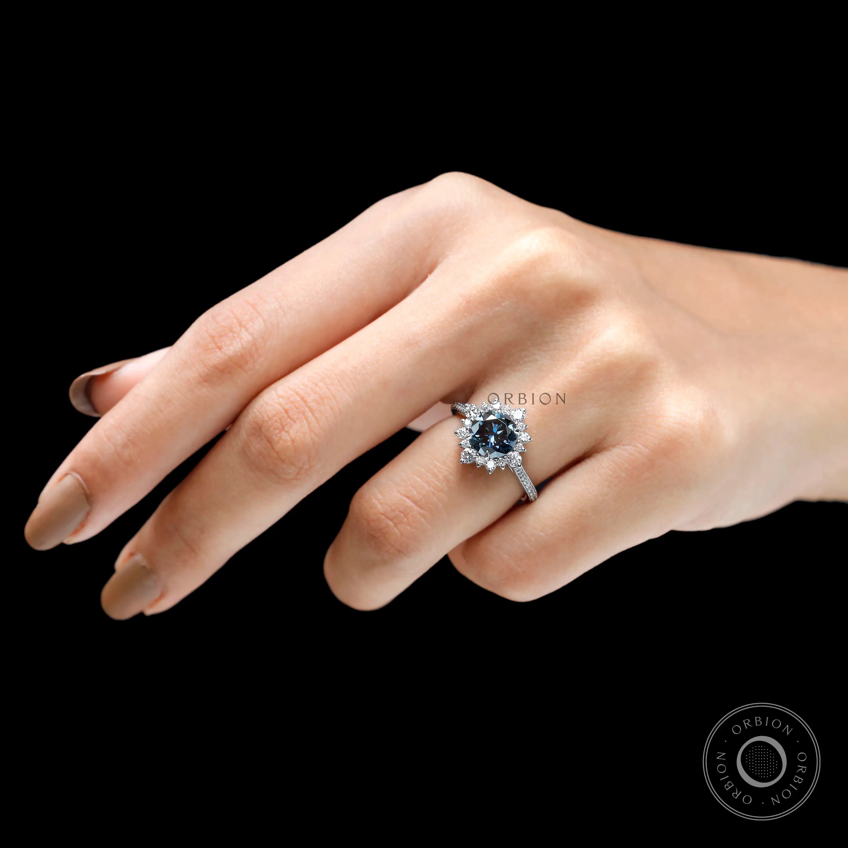 Round grey moissanite halo engagement ring on hand