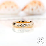 Flush set Asscher cut moissanite wedding band front view on reflective surface