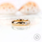 Angled view of solid gold gypsy set wedding band with Asscher cut moissanite