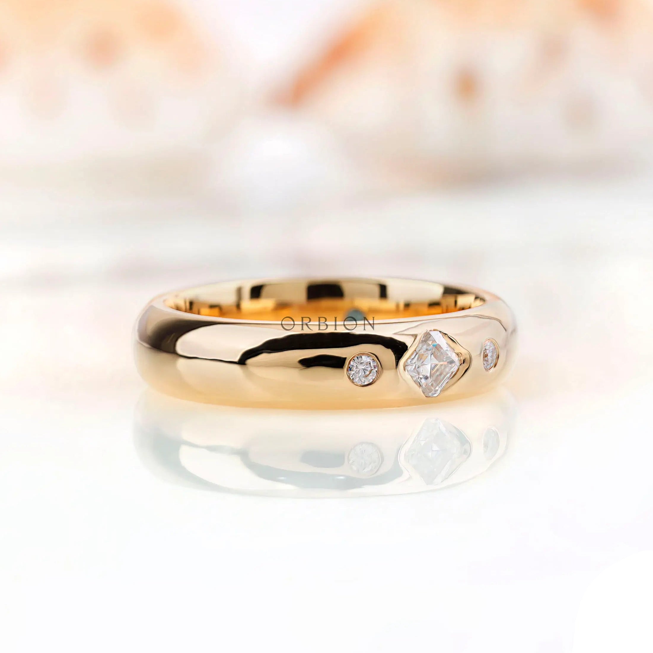 Angled view of solid gold gypsy set wedding band with Asscher cut moissanite