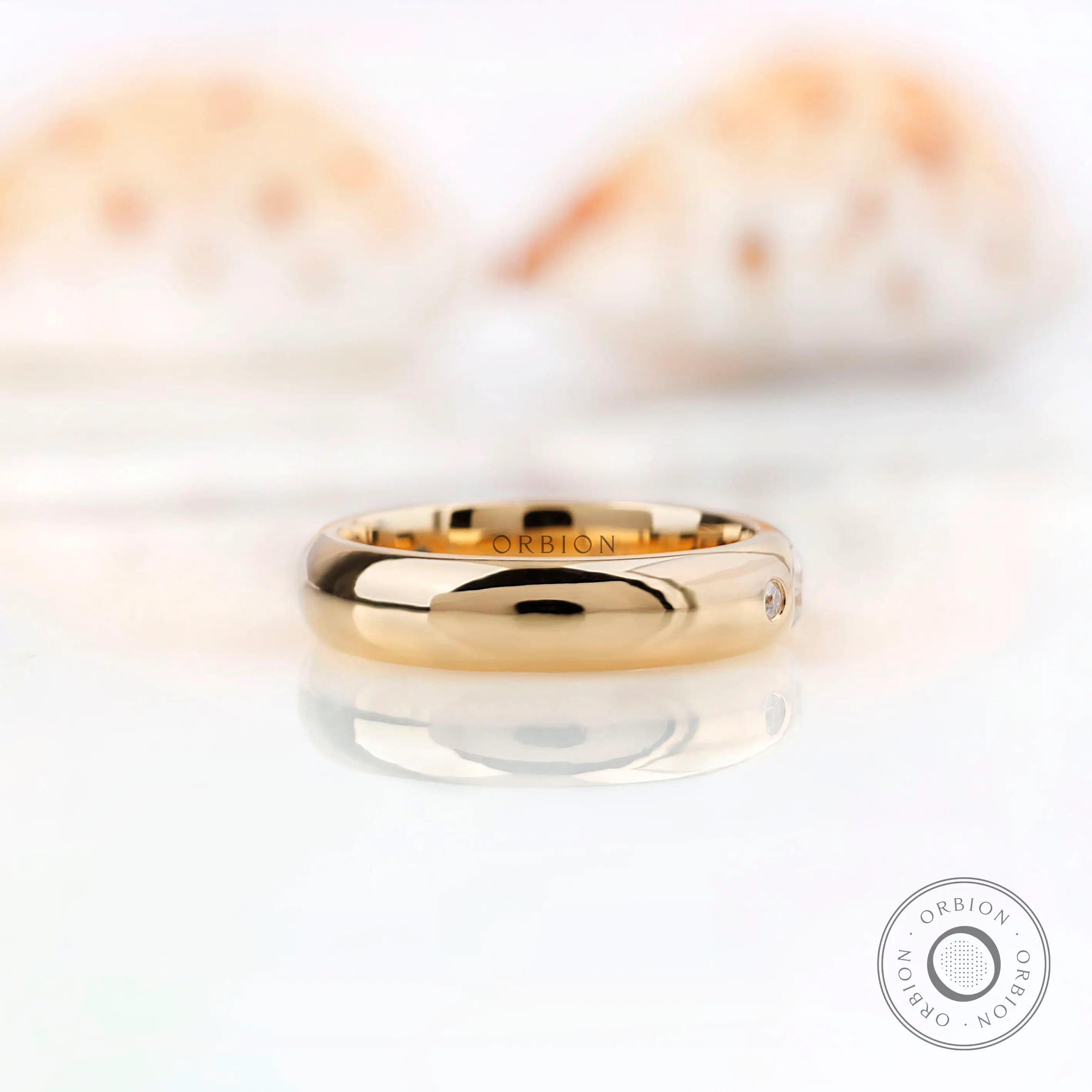 Side profile of flush set moissanite wedding band showing smooth polished gold