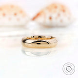 Solid gold wedding band with flush set stones viewed from top angle