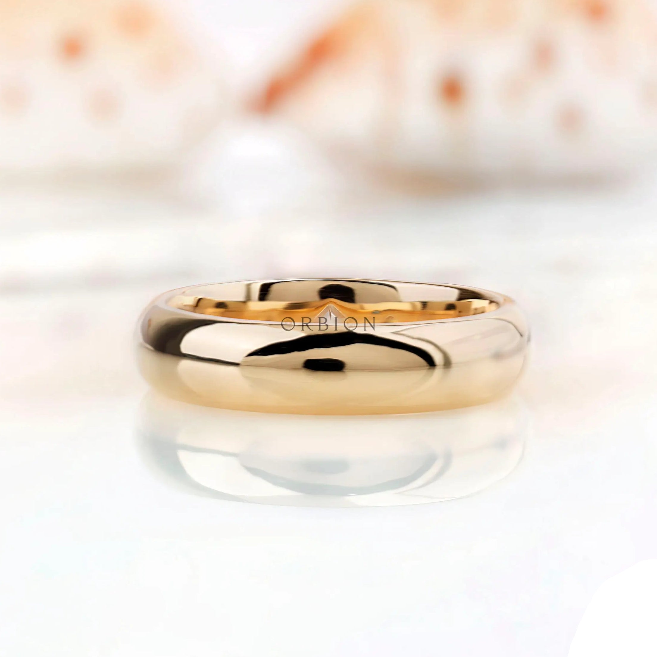 Solid gold wedding band with flush set stones viewed from top angle