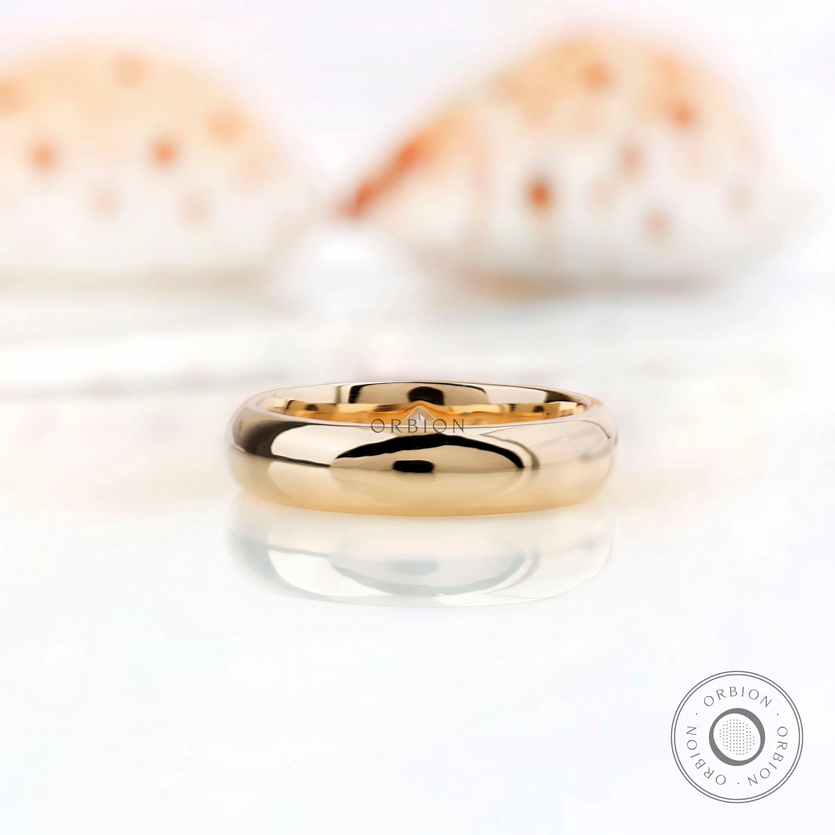Solid gold wedding band with flush set stones viewed from top angle