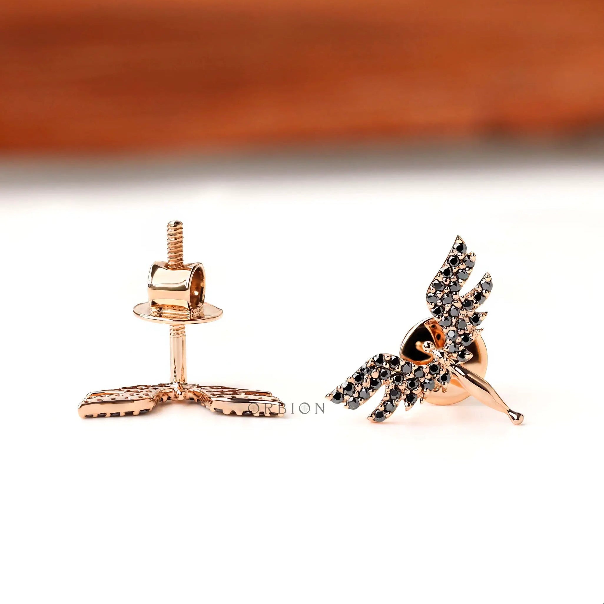 Minimal angel wing stud earrings with black moissanite detailing