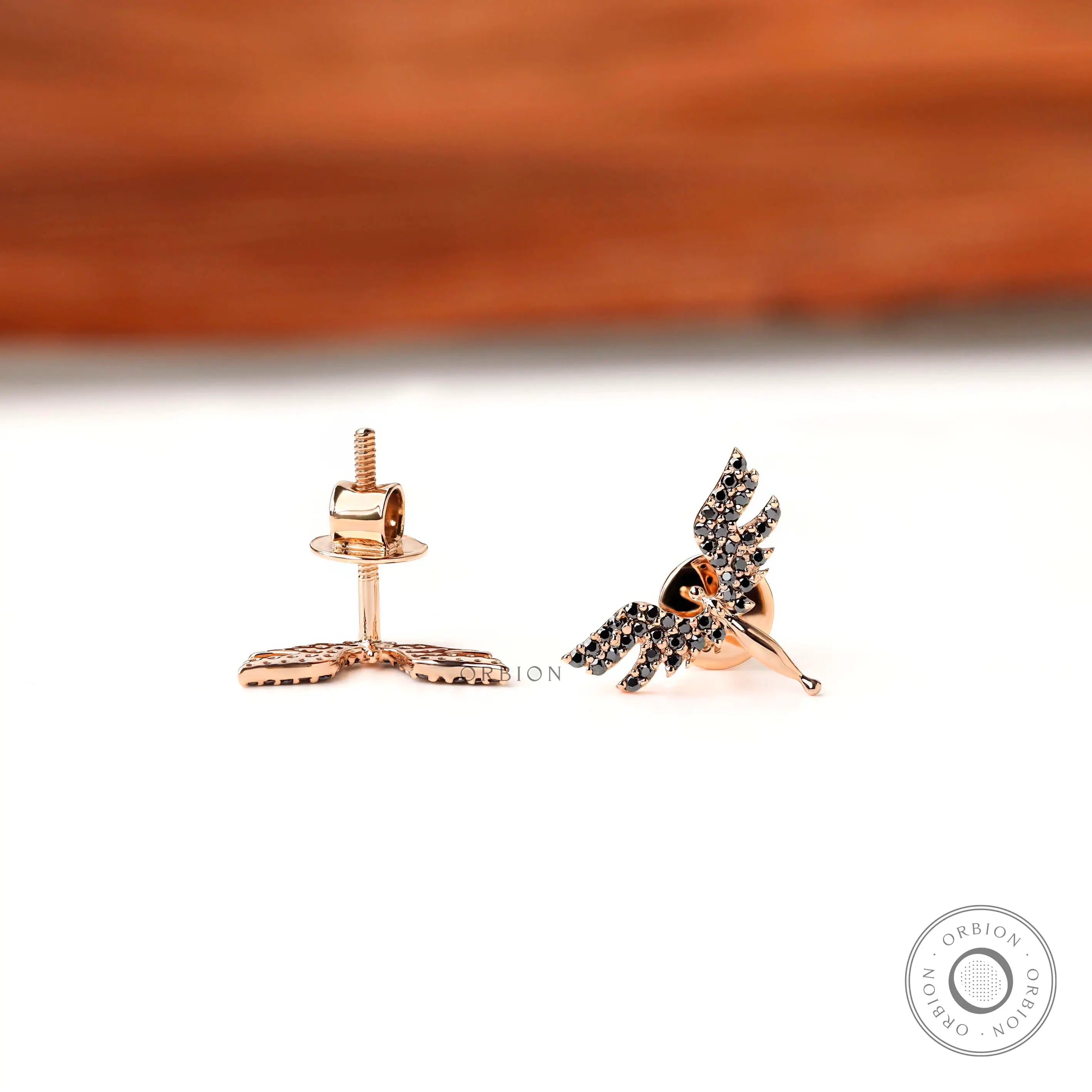 Minimal angel wing stud earrings with black moissanite detailing