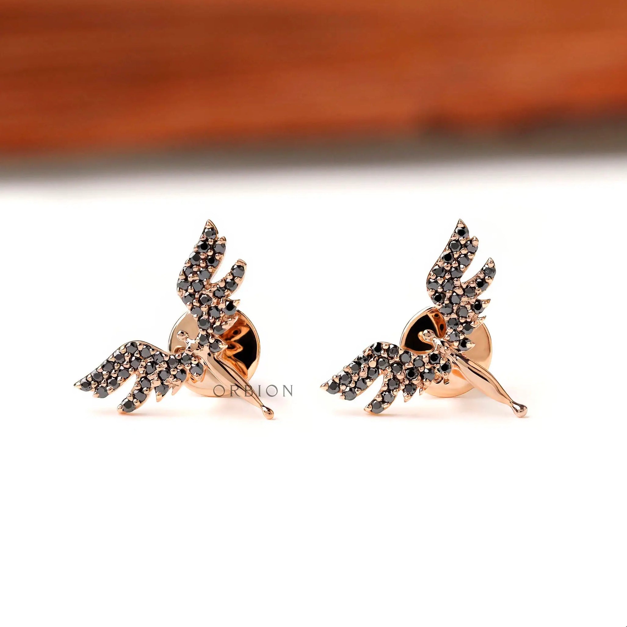 Black moissanite angel wing stud earrings in 18K rose gold