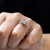 Cushion cluster halo ring on hand, three-quarter angle